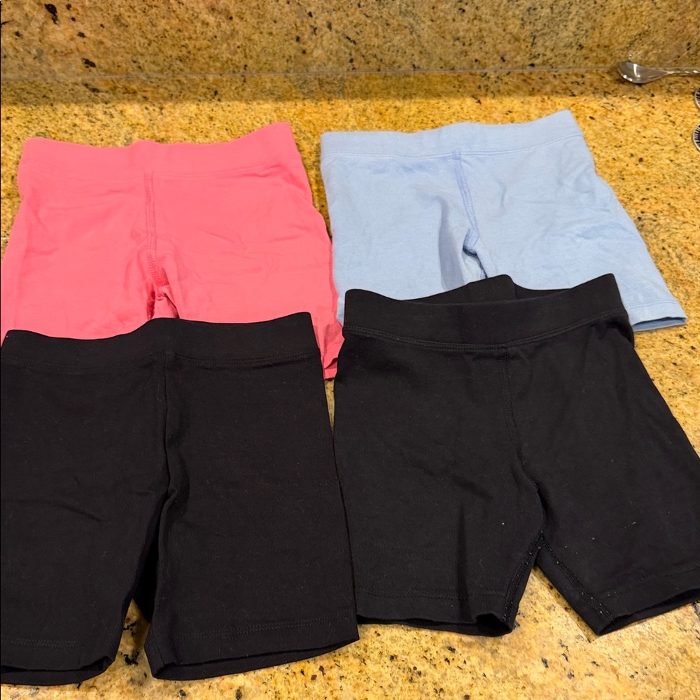 4 pairs of Primary Girls' Active Bike Shorts - Pink, Light Blue, Black